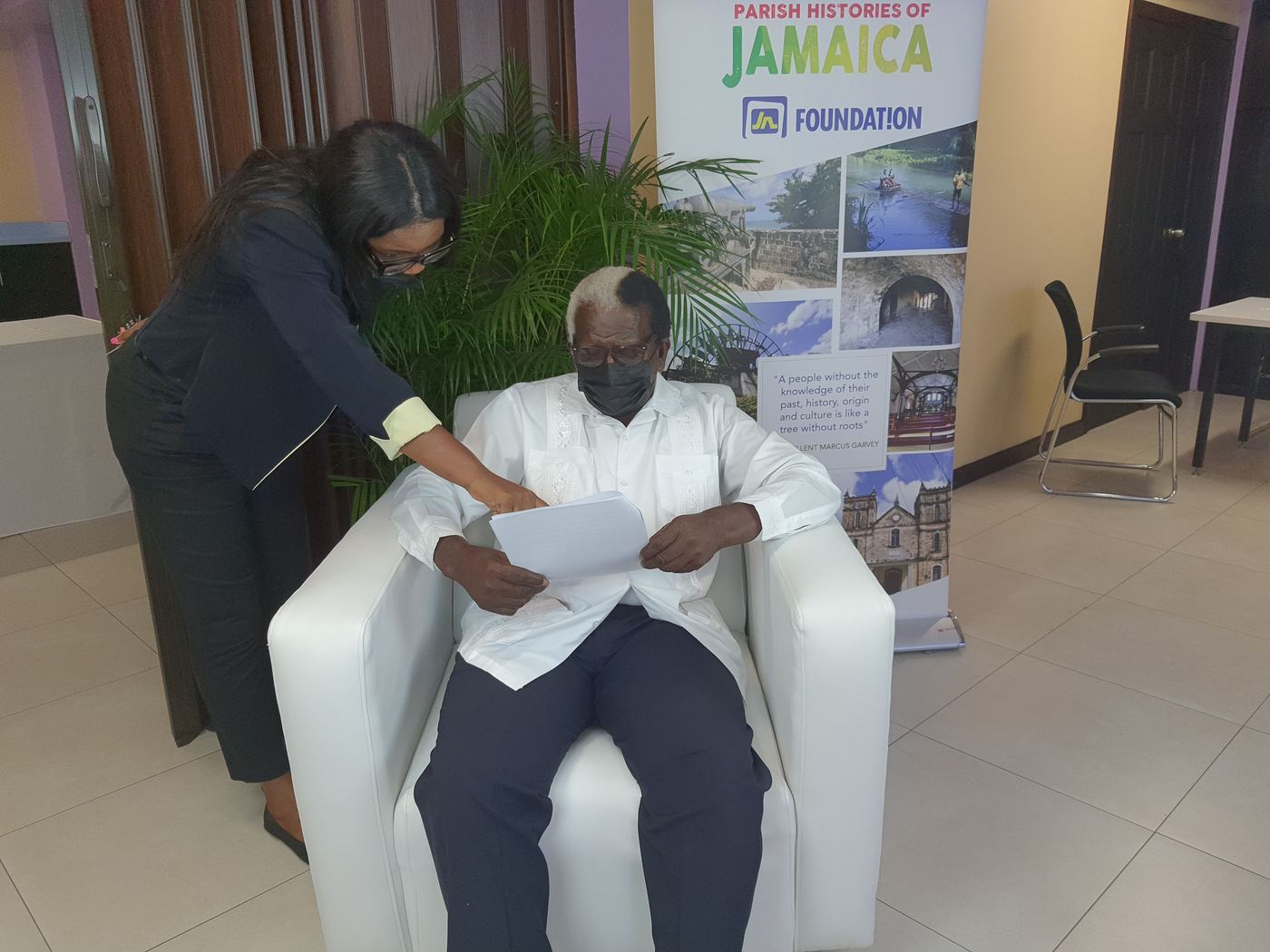 Kadine Reynolds reviewing notes with the Hon. Pearnel Charles Sr before a live taping